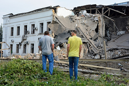 Men look at the 'ACT Alliance' international humanitarian organisation's office building destroyed by a Russian missile strike. In the early morning, the Russian army launched a combined missile attack on Kyiv, using more than 10 cruise missiles and about 10 ballistic missiles of various types. Fragments of intercepted missiles fell in most districts of the capital, in Sviatoshynskyi, Holosiivskyi and Shevchenkivskyi districts with consequences, causing destruction or damage to buildings and transport. At least, three people were injured.