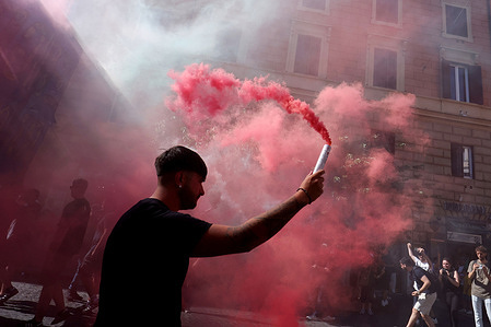Boys light red smoke flares during the procession. Far-right participants from across Italy march in the Prati neighborhood during the demonstration organized by the "Remigration and Reconquest" committee. The march, which began in the afternoon from Piazza della Libertà, crossed Via Cola di Rienzo and ended in Piazza Risorgimento. The event was organized in support of a popular initiative bill on remigration.