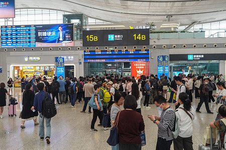 People wait for their trains at Shenzhen North Railway Station in Shenzhen, China. Guangzhou South Railway Station and Shenzhen North Railway Station are two of the largest and most popular railway stations in China. They have great location and play important roles in China's High Speed Railway systems, which connects the trains from different parts of China, including Beijing, Shanghai, Shenzhen, Hong Kong, Changsha, Wuhan and more.