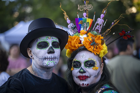 People with painted faces attend Noche de los Muertos at Gloria Molina Grand Park.