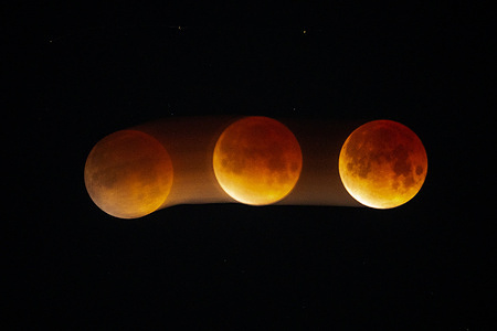 A blood moon lunar eclipse is seen in the sky above Los Angeles. During a total lunar eclipse, the Earth's shadow casts a reddish hue on the moon, commonly known as a blood moon.