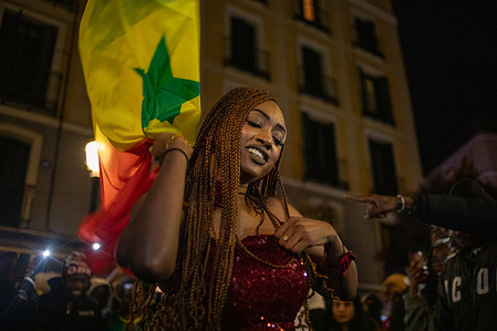 A Senegalese woman dances and celebrates her national team's victory in the center of Madrid. Senegalese and Moroccans gathered at various restaurants in the Lavapiés neighborhood of Madrid to enjoy the Africa Cup of Nations final, which was played tonight in Rabat, Morocco. The final score was Senegal 1, Morocco 0, after extra time. The Senegalese then celebrated in Lavapiés Square.