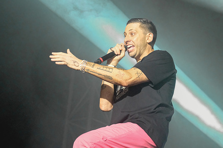 English musician, singer, songwriter, rapper and record producer, Elliot John Gleave known by his stage name Example performing live on stage at the Isle of Wight festival. He got the nickname Example because his initials are EG, an abbreviation of the Latin exempli gratia.