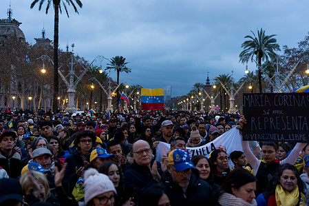 A Venezuelan flag is seen in the crowd during the demonstration. Hundreds of Venezuelan and local people gathered under the Arc of the Trionf monument to celebrate the fall of Venezuelan president Nicolas Maduro following US military intervention in Caracas.