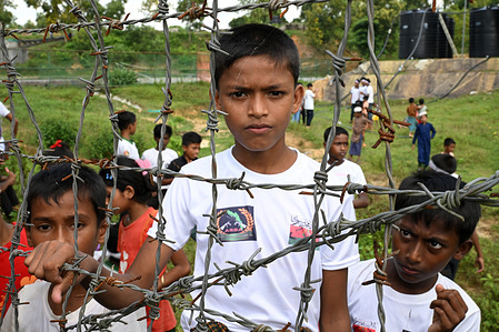 A Rohingya child poses for a photo during a “Genocide Remembrance Day” rally marking the eighth anniversary of their exodus from Myanmar following a military offensive at a refugee camp. Thousands of Rohingya refugees in Cox’s Bazar, Bangladesh, observed “Genocide Remembrance Day” marking eight years since their mass exodus from Myanmar following a brutal military crackdown. Amid shrinking aid and ongoing conflict in Myanmar, refugees continue to demand justice, safety, and a dignified return to their homeland.