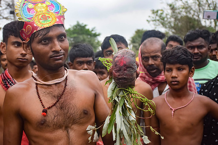 (EDITORS NOTE: Image depicts death) 
A devotee is seen holding a human skull during the Gajon festival at Kurmun village in West Bengal. The Gajon festival or "Shiber Gajon" in West Bengal takes place on the last two days of the month of Chaitra (name of Bengali last month).The central theme of this festival is deriving satisfaction through non-sexual pain, devotion and sacrifice. Devotees collect the remains of dead body parts mainly skulls from different burial grounds and before the day of Gajon they carry human skulls in a procession to appease Hindu Lord Shiva.