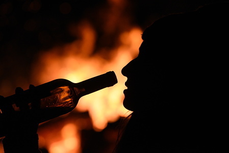 A woman is seen drinking wine near a bonfire during 'Las Luminarias' tradition in the small village of Rebollo de Duero, north of Spain. The tradition, which is hundreds of years old, is meant to purify and protect, with a big bonfire, the animals and people in the coming year. Hundreds of villages and towns of Spain celebrated this tradition during centuries, but nowdays the celebration has been lost in many of them.