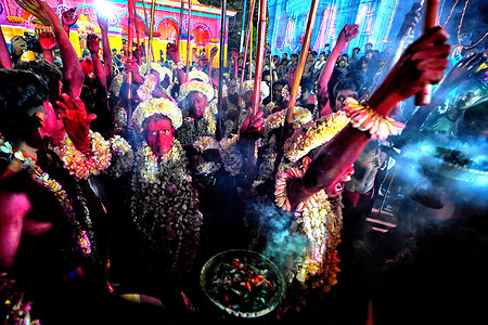 Hindu devotees with their faces and bodies painted with Red color seen during the annual Gajan Festival. Gajan is a Hindu festival celebrated mostly in the rural part. The festival is related to Lord Shiva and as per Mythology on the last day of Bengali Calendar (Middle of April) devotees used to worship dead bodies to satisfy Lord Shiva for better rain and harvest. The central theme of this festival is deriving satisfaction through non-sexual pain, devotion and sacrifice.