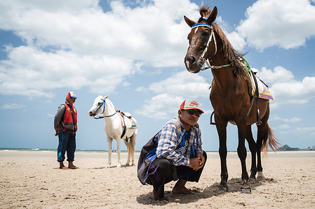 Horse handlers wait for customers along the beach. Daily life moves at a slower pace with local businesses reporting fewer visitors amidst broader tourism slowdown. From January to mid-July, the country recorded 17.75 million foreign arrivals, a 5.62% drop from last year with popular destinations feeling the impact.