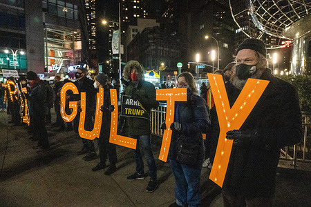 Protesters hold a lit sign reading "Trump is guilty" during the RefuseFascism march in front of Trump International Hotel in Columbus Circle.
Protesters congregated on Times Square and marched to Columbus Circle, Trump International Hotel blocking traffic along the way and were later met with other protestors from Rise and Resist.