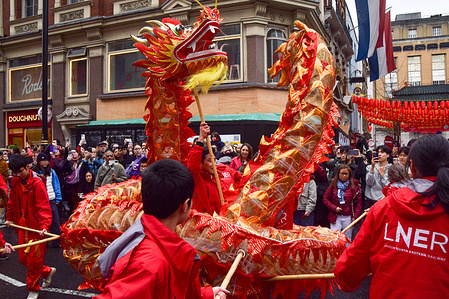 Performers pass with a dragon through Shaftesbury Avenue during the Chinese New Year parade in Central London. This year is the Year of the Horse.