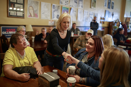 New York Democratic Senator Kirsten Gillibrand campaigns for President of the United States as she shakes hands of her supporters during a "listening tour" stop at at the Adams Street Espresso & Soda Shoppe in Creston, Iowa. 
More than a dozen Democratic party candidates are campaigning in the state of Iowa to win the Iowa Democratic Caucuses February 3, 2020. The Iowa Caucuses is part of a series of primary elections in the United States that will help the Democratic party decide the candidate that will be the opponent of United States President, and defacto leader of the Republican party, Donald J. Trump. The United States has two dominant political parties that compete for power although there are more than two parties. The party that wins the presidential election has enormous power in the United States' representative democracy system of governance. A United States president can serve for a total of 8 years, but must be reelected after 4 years. Other early important primary elections are in South Carolina and New Hampshire, and candidates are campaigning now in those states as well. Running for President of the United States costs millions of dollars and a candidates political skills are just as important as their fundraising skills, or access to money.