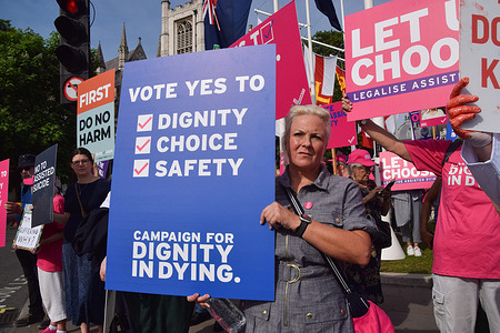A protester supporting the Assisted Dying Bill holds a 'Vote Yes' placard during the demonstration. Both supporters and opponents of the Assisted Dying Bill gathered in the Parliament Square as Members of Parliament continue to debate the bill.
