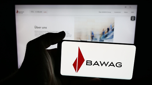 In this photo illustration, a mobile phone with the logo of Austrian financial services company BAWAG is seen on screen in front of web page.