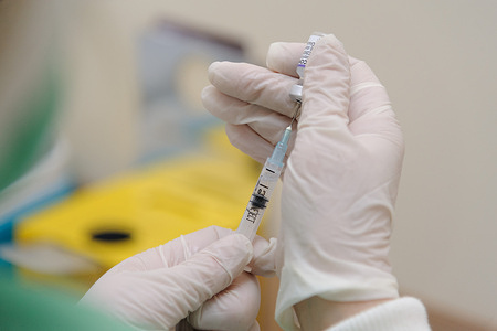 A health worker prepares a doze of Comirnaty (Pfizer) vaccine at a hospital.
Ukraine has recorded a total of 3.09 million cases and 73,136 deaths due to covid 19.