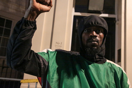 A man stands outside the Embassy of the United Arab Emirates in London, clenching his fist during the protest. Protesters accused the United Arab Emirates of funding Sudan’s Rapid Support Forces, a militia blamed for atrocities in the country’s civil war. As fighting devastates Sudan, demonstrators gathered outside the UAE Embassy in London demanded an end to foreign interference and accountability for those fueling the conflict.
