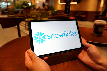 In this photo illustration, the Snowflake logo is displayed on the screen of a smart tablet.