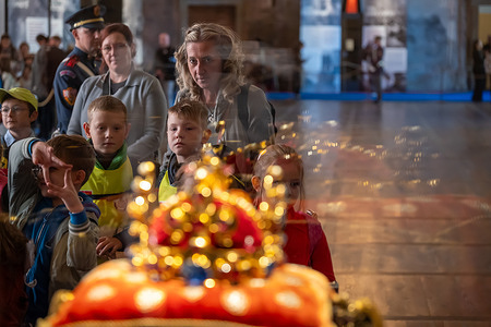 Visitors observe Czech Crown Jewels with the St. Wenceslas Crown during the exhibition in Vladislav Hall at Prague Castle. The Bohemian Crown Jewels are considered some of the oldest in Europe and are usually displayed to the public once a year in occasion of national holiday of St. Wenceslas. Vladislav Hall at Prague Castle will exhibit the jewels for public from 18th to 29th September 2025.