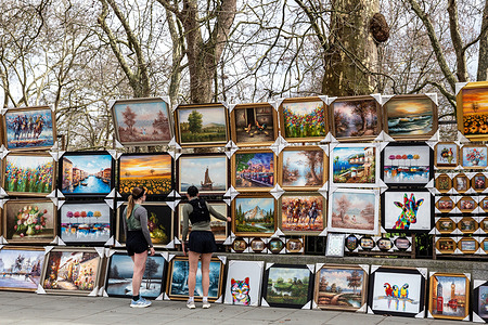 Women watch art in central London as the UK's economy remains slow and inflation is expected to grow again.