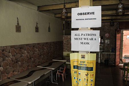 View of posters detailing covid-19 preventive measures are seen pasted on an iron pillar inside an empty café in Nakuru Town.
Recent Covid-19 restrictions reduced gatherings as a preventive measure against a new wave of infections, so to hotels only serving take-away food it has led to increased job losses and decreased revenues in hotels across the country.