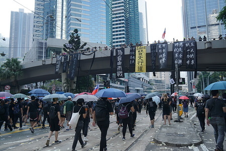 Protesters holds umbrellas while marching during the anniversary in Hong Kong.
Anti-government protests spread out on the streets and protesters pose a direct challenge to Chinese President Xi Jinping on the 70th anniversary National day of the country.