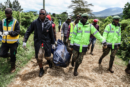 (EDITORS NOTE: Image depicts death)
Rescuers carry the body of a young man recovered in the debris following a flooding tragedy. Water Cabinet Secretary Zechariah Njeru attributed the incident to a blocked railway line tunnel, hindering the flow of water through River Tongi. Debris from heavy rainfall, including stones, trees, and soil, obstructed the channel, preventing the river and its tributaries from flowing downstream. This resulted in the bursting of river banks and the rapid downstream flow, leading to the observed destruction. The search and rescue operation continues in Mai Mahiu, Nakuru County, where 28 people are still missing after a flooding tragedy. Deputy President Rigathi Gachagua stated that at least 71 people have been confirmed dead.
