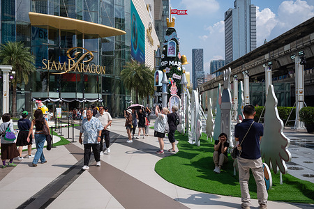 People take photos around Pop Mart decorations outside the Siam Paragon shopping mall. The Pop Land Exclusive Festive is held by Pop Mart and the Tourism Authority. The pop-up event is the largest one by Pop Mart in the world.