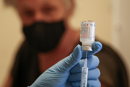 A health worker prepares to administer the Covid-19 booster vaccine, at a vaccination centre.