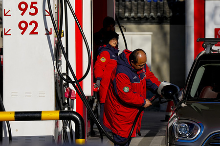 A service station employee pumps fuel into a vehicle China will raise retail gasoline and diesel prices in Beijing as global oil prices surge, with the government adjusting fuel price caps to reflect rising international crude costs. The move, China’s largest fuel price hike in about four years, comes after oil markets spiked amid escalating conflict involving Iran, pushing up global benchmarks and forcing Beijing to pass part of the cost to domestic consumers.