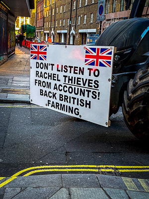 A tractor with a placard is seen in central London after Chancellor Rachel Reeves delivered her Budget of tax increase.