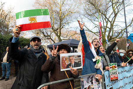 Protesters chanting. Members of the Iranian diaspora gathered outside the Iranian Embassy in London following recent anti-government protests in Iran, calling on US President Donald Trump to help bring an end to the Islamic Republic. Demonstrators voiced support for regime change and demanded international backing for the return of Shah Pahlavi and the restoration of the monarchy, waving Iranian flags and chanting anti-government slogans.