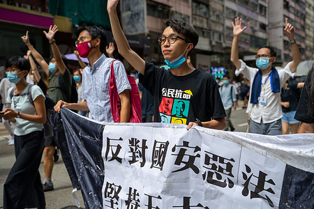 Demonstrators seen holding a banner which reads "No to national security laws; insist the 5 demands". Other protesters march in defiance of police ban despite security law, whilst raising their hands up to signal “Five demands, not one less".
Thousands took to the streets of Hong Kong on the 23rd anniversary of the handover from Britain to China in defiance of police ban. The day also marks the first day of the implementation of the controversial national security law imposed by Beijing, which many seen as a blatant attack to human rights in the city.