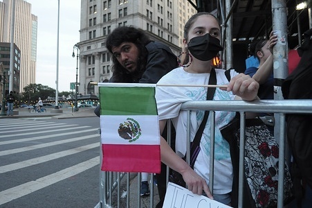 An anti-ICE demonstrator waves the Mexican flag at a rally near Foley Square, Manhattan, New York City. Demonstrators in Manhattan protested against Donald Trump’s immigration policies and the U.S. Immigration and Customs Enforcement or ICE for arresting and deporting immigrants. The protest occurred amid other anti-ICE protests happening in cities nationwide. The rallies began following protests in Los Angeles last week opposing ICE immigration raids.