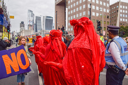 Extinction Rebellion's Red Rebel Brigade perform during the protest.
Extinction Rebellion protesters blocked the streets next to London Bridge with a bus, as part of their two-week Impossible Rebellion campaign, calling on the UK Government to act meaningfully on the climate and ecological crisis.