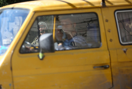 A Palestinian man drives past an Israeli military vehicle guarding religious Jews who entered Joseph's Tomb. Dozens of Israelis illegally entered the site which is under Palestinian security control. Israeli forces then entered the area to secure their exit.