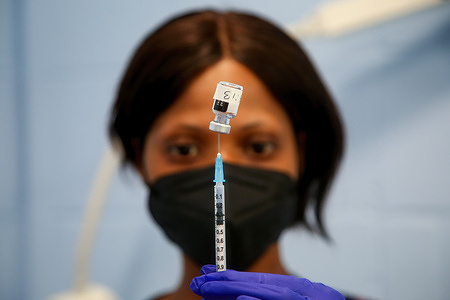 NHS health work prepares to administer Pfizer Covid-19 vaccine at a vaccination centre.