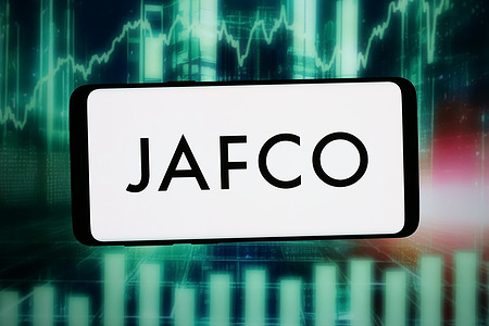 In this photo illustration, the logo of investment company JAFCO Group Co. Ltd is displayed on a smartphone in front of abstract background on computer screen.
