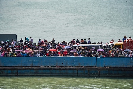 Migrant people get onto an overcrowded ferry to travel home to celebrate Eid al-Fitr amid concerns over the coronavirus disease (COVID-19) outbreak in Munshiganj on the outskirts of Dhaka

Despite the suspension on daytime ferries and the deployment of BGB (Border Guards Bangladesh) troops, the crowds of people hoping to make their way home for Eid are still swelling at Shimulia, a river port.