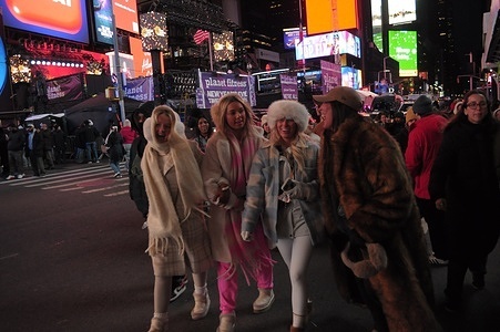 People walk in Times Square, Manhattan, New York City.