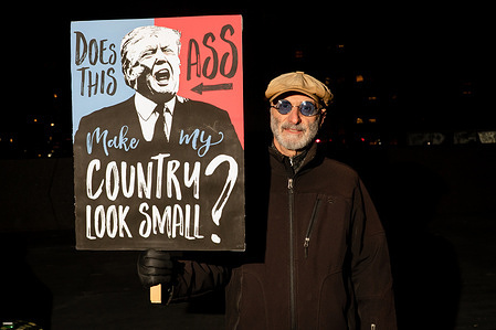 A protester with an image of president Donald Trump, saying "Does This Ass Make MY Country Look Small?" during a protest in New York City against U.S. Immigration and Customs Enforcement (ICE) at Foley Square. The protest was in response to an Immigration and Customs Enforcement (ICE) agent who fatally shot 37-years-old Renee Nicole Good in her car in Minneapolis, Minnesota, United States.