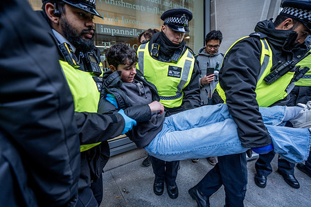Non-compliant Pro-Palestinian protestors are manhandled towards Police Vans after refusing to walk. Scores of Palestine Action protestors were arrested outside the Ministry of Justice for holding up signs in support of the proscribed group. The mass action is part of a renewed nationwide campaign leading up to the judicial review of the Palestine Action ban under the Terrorism Act in one week’s time.