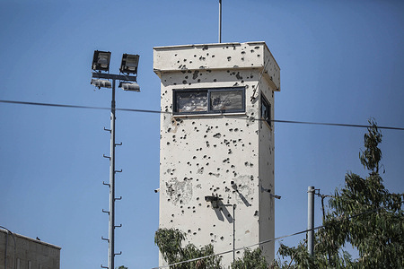 A view of the Palestinian Authority military tower damaged with bullet holes in the Jenin refugee camp. Israeli military bulldozers demolish Palestinian homes inside the camp. Israeli forces have besieged Jenin camp for 167 days during Operation Iron Walls on West Bank refugee camps.