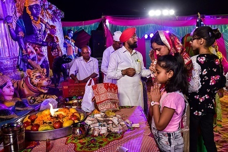 Devotees seen praying during the ritual.
Jagran is a Hindu ritual, consisting of all-night vigil, songs and dance in honor of a deity and puja. Jagran is performed in honor of various Hindu goddesses.