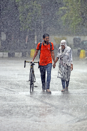 A couple seen walking along an empty and deserted road during a rainy day amid the covid-19 lockdown.
The country went into a strict lockdown and Heavy monsoon downpour caused extreme water logging in most areas of Dhaka city. Roads were submerged making travel slow and dangerous.