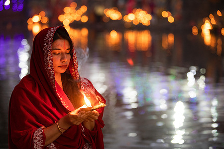A Nepalese Hindu devotee offers an oil lamp to the Sun God after prayers on the banks of the holy Bagmati river during the Chhath festival in Kathmandu. During Chhath, an ancient Hindu festival, rituals are performed to thank the sun god for sustaining life on earth. Chhath Puja is a Hindu festival where devotees pray to the sun god and offer Prasad and special delicacies at sunset and before sunrise and end their fast by eating 'Prasad' and special delicacies. 