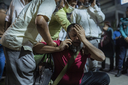 A relative of one of the victims mourns after an explosion in a multi storey building that killed several people at Gulisthan in Dhaka. At least 15 people were killed and more than 100 were injured in Bangladesh's capital after an explosion inside an office building in a bustling commercial district, police said.