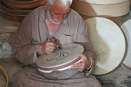 Mustafa Yesilkaya, one of the last tambourine masters seen making a tambourine in his workshop. Mustafa Yesilkaya, a 68-year-old artist, has been handcrafting tambourines in his workshop for 50 years. He is one of the last remaining masters of this traditional art, which is used in both religious rituals and musical performances. Yesilkaya notes that younger generations are showing little interest in continuing the craft.