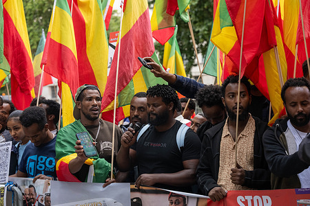 A man speaks as demonstrators carrying Ethiopian flags and placards, including one reading "Stop [Amhara]," gather during the rally. Members of the Amhara community held a protest against what they describe as an ongoing campaign of ethnic cleansing and genocide against the Amhara people by the Ethiopian government.
The Amhara are one of Ethiopia's largest ethnic groups. Since armed conflict escalated between government forces and the Fano militia in the Amhara region in April 2023, rights groups and Amhara diaspora organisations have accused Prime Minister Abiy Ahmed's government of mass killings, displacement and drone strikes against Amhara civilians, allegations the Ethiopian government denies. The conflict has prompted repeated demonstrations by the Amhara diaspora in London and other cities calling for international intervention.