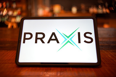In this photo illustration, the Praxis' logo is displayed on the screen of a smart tablet.