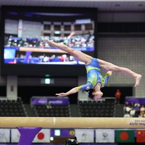 Japanese artistic gymnast Mana Okamura competing on the balance beam during the Women's Artistic Gymnastics Team Final at the 20th Asian Games Aichi-Nagoya 2026, held at the Nagoya General Gymnasium, Rainbow Hall.